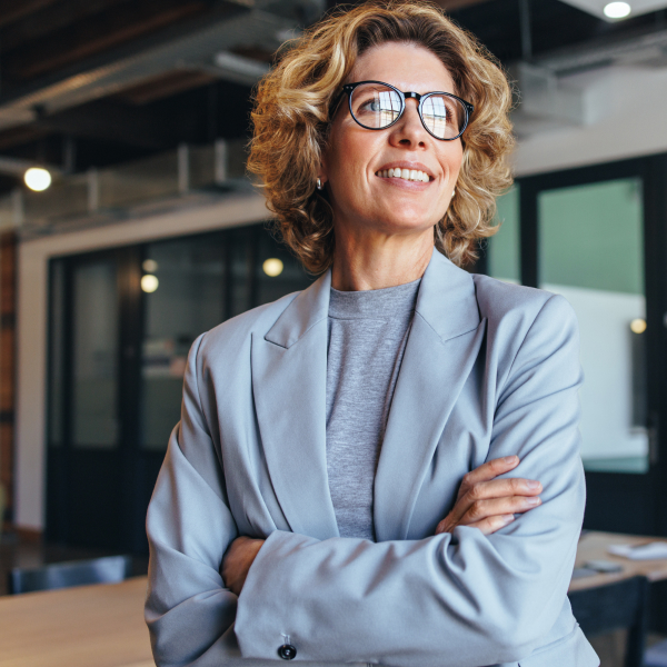 WOW Resource Group - photo of an older business woman smiling with arms crossed.